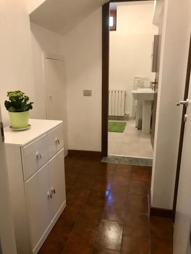 a kitchen with a white cabinet and a mirror at Tramonto in Cà delle Isole in Stresa