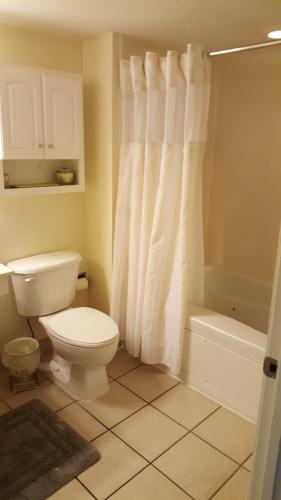 a bathroom with a toilet and a tub and a shower at JeffsCondos - 3 Bedroom - Breakers Resort in Myrtle Beach