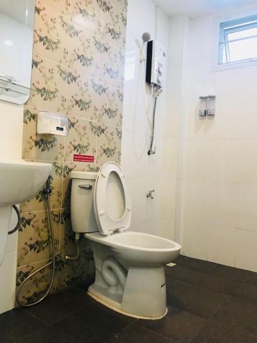 a bathroom with a toilet and a sink at SAB Residence in Pattaya South