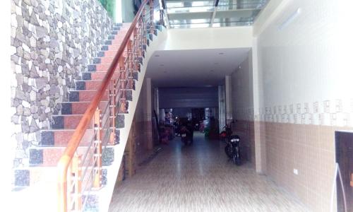 a hallway of a building with a staircase and a bike at Ruby Hostel Hà Giang in Ha Giang