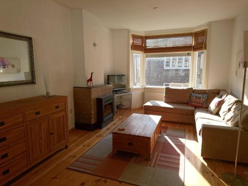 a living room with a couch and a coffee table at Hiltje - Nice to stay in Dordrecht