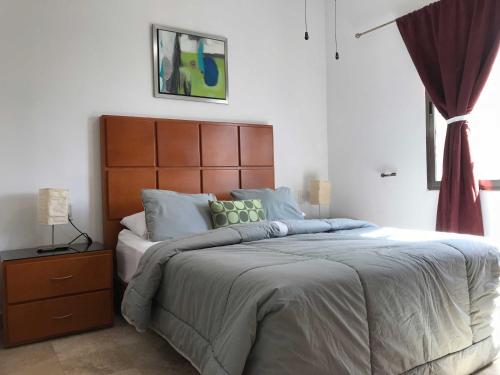 En eller flere senge i et værelse på Lilas del Mar Apartments