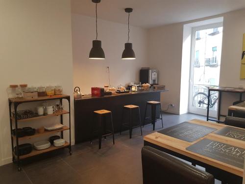 a kitchen with a counter and stools in a room at Art Street Hotel in Naples