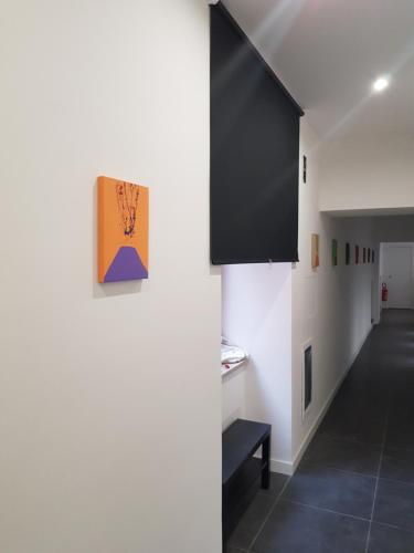 a room with a hallway with white walls and black floors at Art Street Hotel in Naples