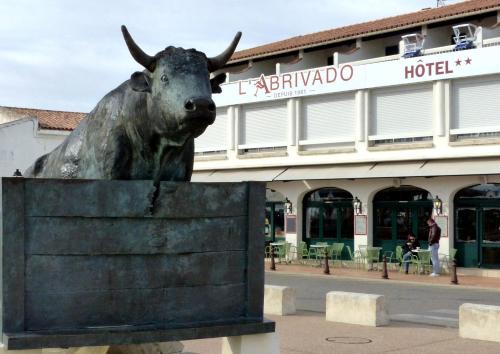 a statue of a bull in front of a hotel at Abrivado in Saintes-Maries-de-la-Mer
