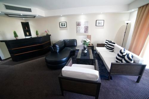 a living room with a couch and a chair at Savoy Hotel Boutique in Las Terrenas