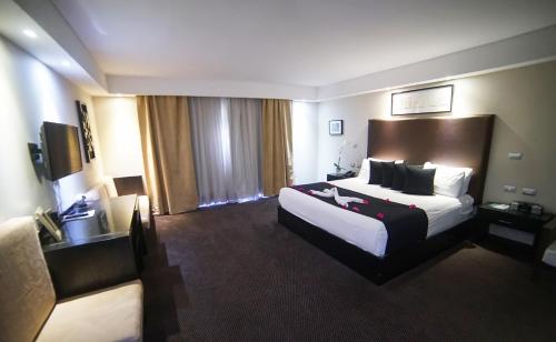 a large hotel room with a large bed in it at Savoy Hotel Boutique in Las Terrenas