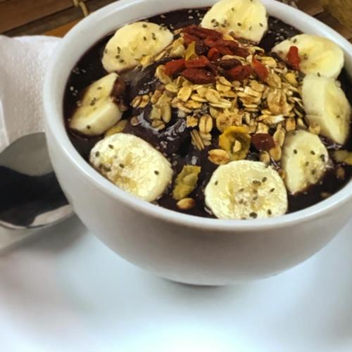 a bowl of soup with bananas and nuts at Caju Bangalôs in Ponta do Anel