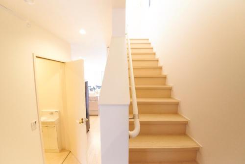 a staircase in a house with a white door at Kyoto river side modern House in Kyoto