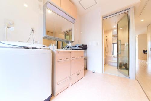 a bathroom with a sink and a mirror at Kyoto river side modern House in Kyoto