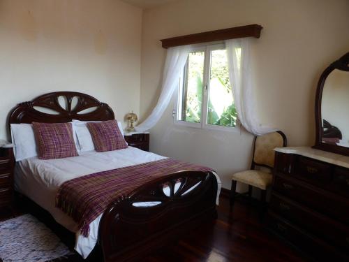 een slaapkamer met een groot bed en een raam bij Ocean Paradise BEACH VILLA Paul do Mar in Paul do Mar