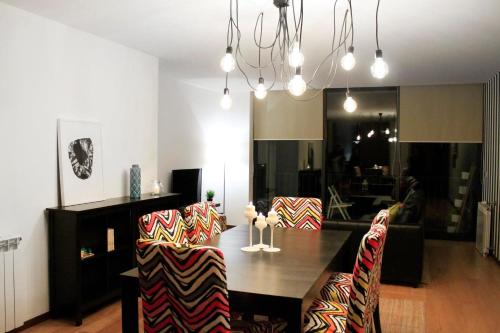 a living room with a dining room table and chairs at Caldas do Gerês Apartment in Geres