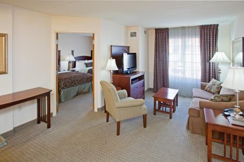 a hotel room with a bed and a living room at Staybridge Suites Indianapolis Downtown-Convention Center by IHG in Indianapolis