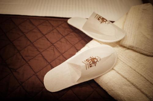a pair of white shoes sitting on a bed at Gran Paradiso Hotel Spa in San Giovanni Rotondo