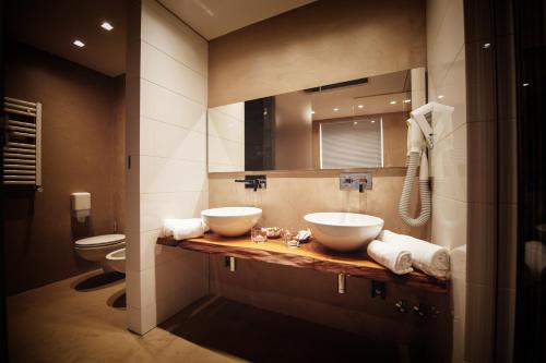 a bathroom with two sinks and a toilet at Gran Paradiso Hotel Spa in San Giovanni Rotondo