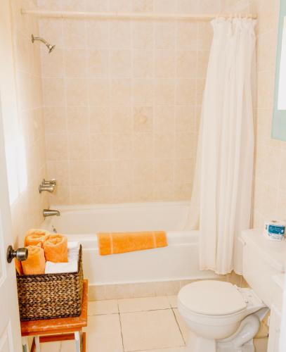 a bathroom with a white tub and a toilet at Taino Cove in Treasure Beach