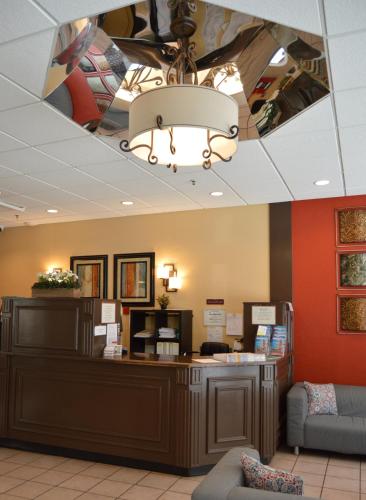 a lobby with a waiting area with a chandelier at SF Plaza Hotel in San Francisco