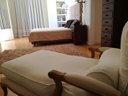 a living room with a couch and a chair at Endless Blue in Anavissos