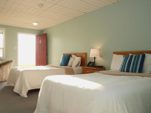 a bedroom with two beds and a window at Sands on Golden Lake in Golden Lake