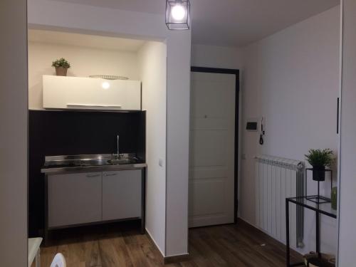 a kitchen with a sink and a counter in a room at Attico Da Rosa con vista spettacolare a 360 gradi in Caltagirone
