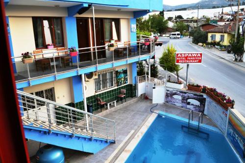 a hotel with a swimming pool in front of a building at Aspawa Hotel in Pamukkale