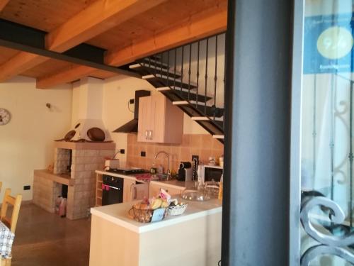 a kitchen with a staircase in a house at B&B Corte Preare in Lavagno