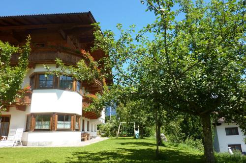a building with a tree in front of it at Haus Moosanger in Oberau