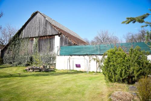 an old barn with a green tarp on it at Chalupa u Manišov in Laskár