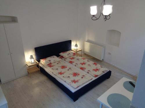 a bedroom with a bed and two night stands at Alexandra Studios in Sibiu