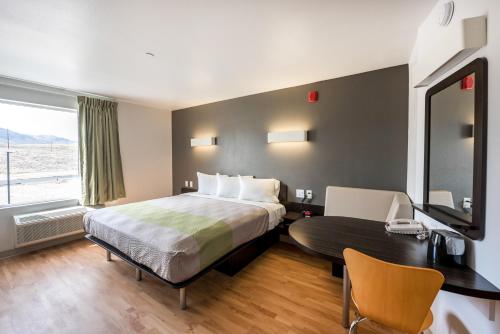a hotel room with a bed and a desk and a window at Studio 6-Mccarran, NV - Sparks - Tahoe - Reno Industrial Center in Clark