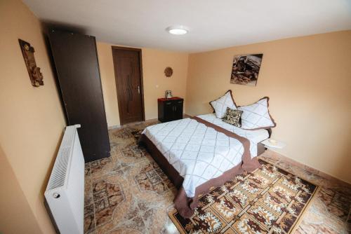 a bedroom with a bed and a tv in it at Casa Andreia in Gura Humorului