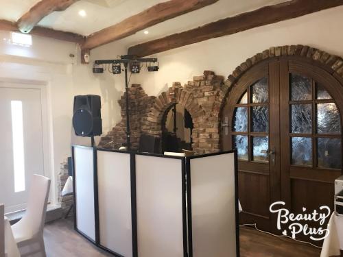 a room with a stage with a door and a tv at Hotel-Restaurant Haus Nattkemper in Hamm