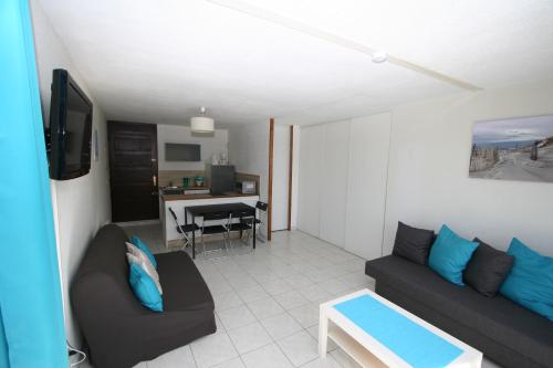 un salon avec un canapé et un bureau dans l'établissement Front de Mer, au Barcarès