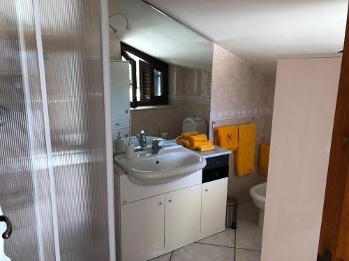 a bathroom with a sink and a toilet at Clementine's House in Acireale