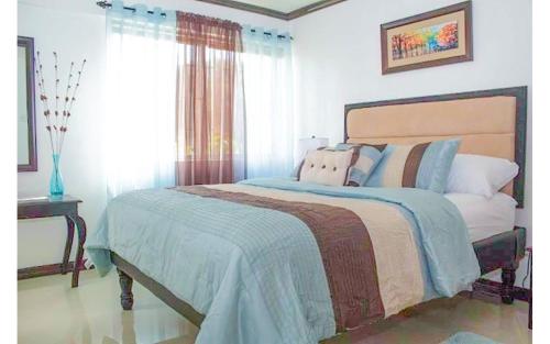 a bedroom with a bed with pillows and a window at Coconut Shell At Turtle Towers in Ocho Rios