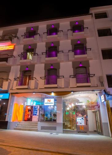 a building with purple lights on the front of it at Hotel Nomada in Pozoblanco