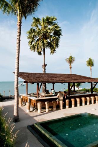 a pavilion at the beach with palm trees and a swimming pool at Hansar Samui Resort & Spa - SHA Extra Plus in Bophut 