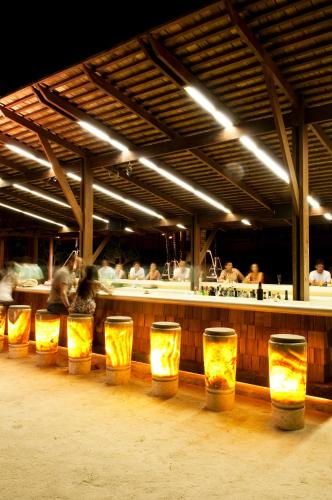 a row of yellow barrels in front of a restaurant at Hansar Samui Resort & Spa - SHA Extra Plus in Bophut 