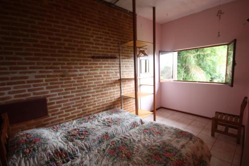 Una cama o camas en una habitación de Pousada Campestre Sítio da Lua