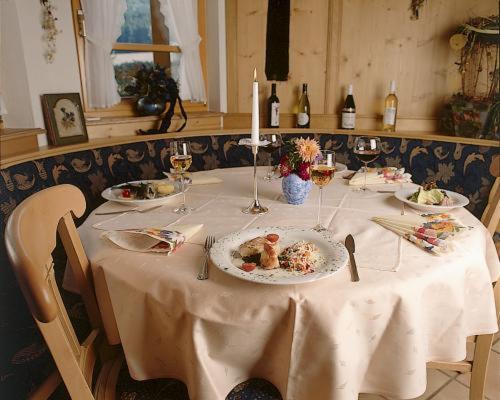 a table with plates of food and candles on it at Hirschen-Dorfmühle in Biederbach Baden-Württemberg
