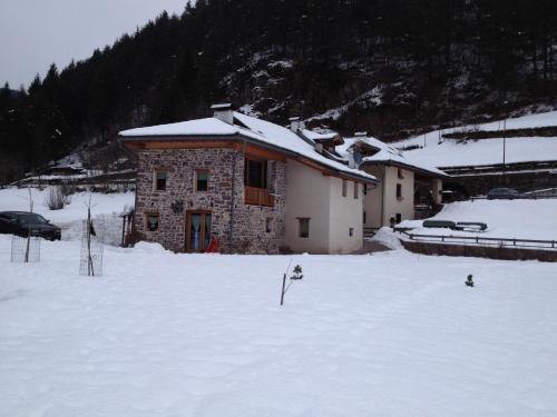 a building in the snow in front at Maso Toneto in Castello di Fiemme