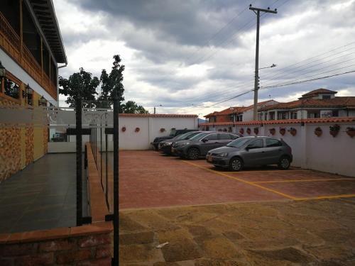 a group of cars parked in a parking lot at Hotel El Giro in Villa de Leyva