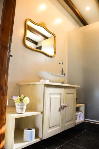 a bathroom with a sink and a mirror at Posada Boutique La Barrica in San Rafael