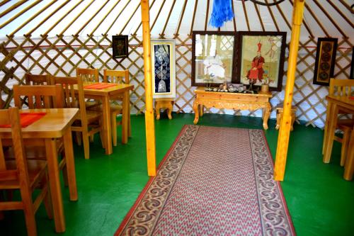 a room with tables and chairs in a yurt at Danista Nomads Tour Hostel in Ulaanbaatar