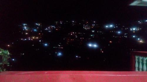 a view of a city at night with lights at I.K Homestay in Kohīma