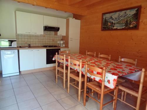 a kitchen with a table and chairs in a room at chalet 2007 in Le Boulay