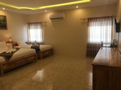 Katil atau katil-katil dalam bilik di Leego Hotel