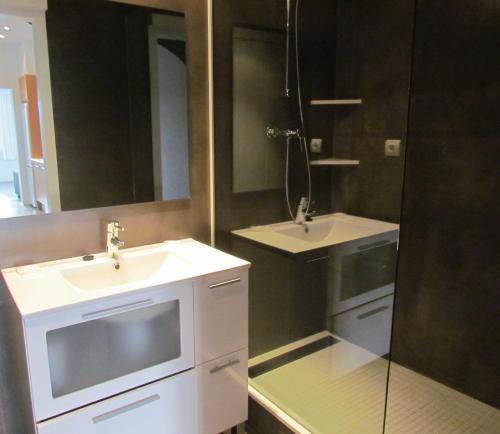 a bathroom with two sinks and a shower at Carpe Diem Cadaqués in Cadaqués