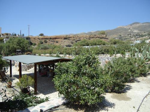 a garden with a pavilion with trees and bushes at Mythos Suites Diskos in Léntas
