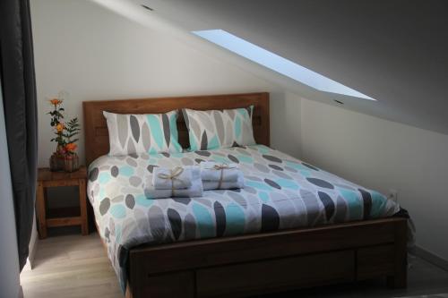a bedroom with a bed with two towels on it at Le Clos du Square - climatisé in Rochefort